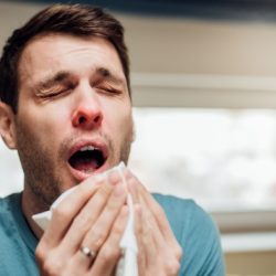 A food handler sneezes and then returns