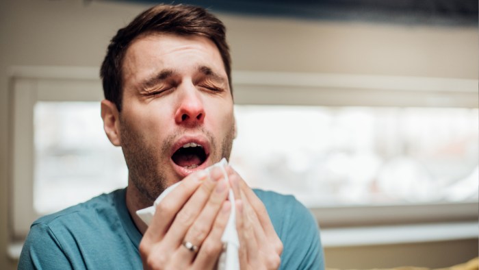 A food handler sneezes and then returns